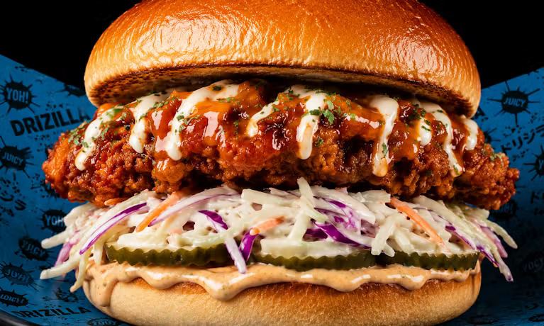 Drizz Buff Burger Crispy chicken fillet tossed in fiery buffalo sauce, topped with crunchy lettuce and fresh chives.