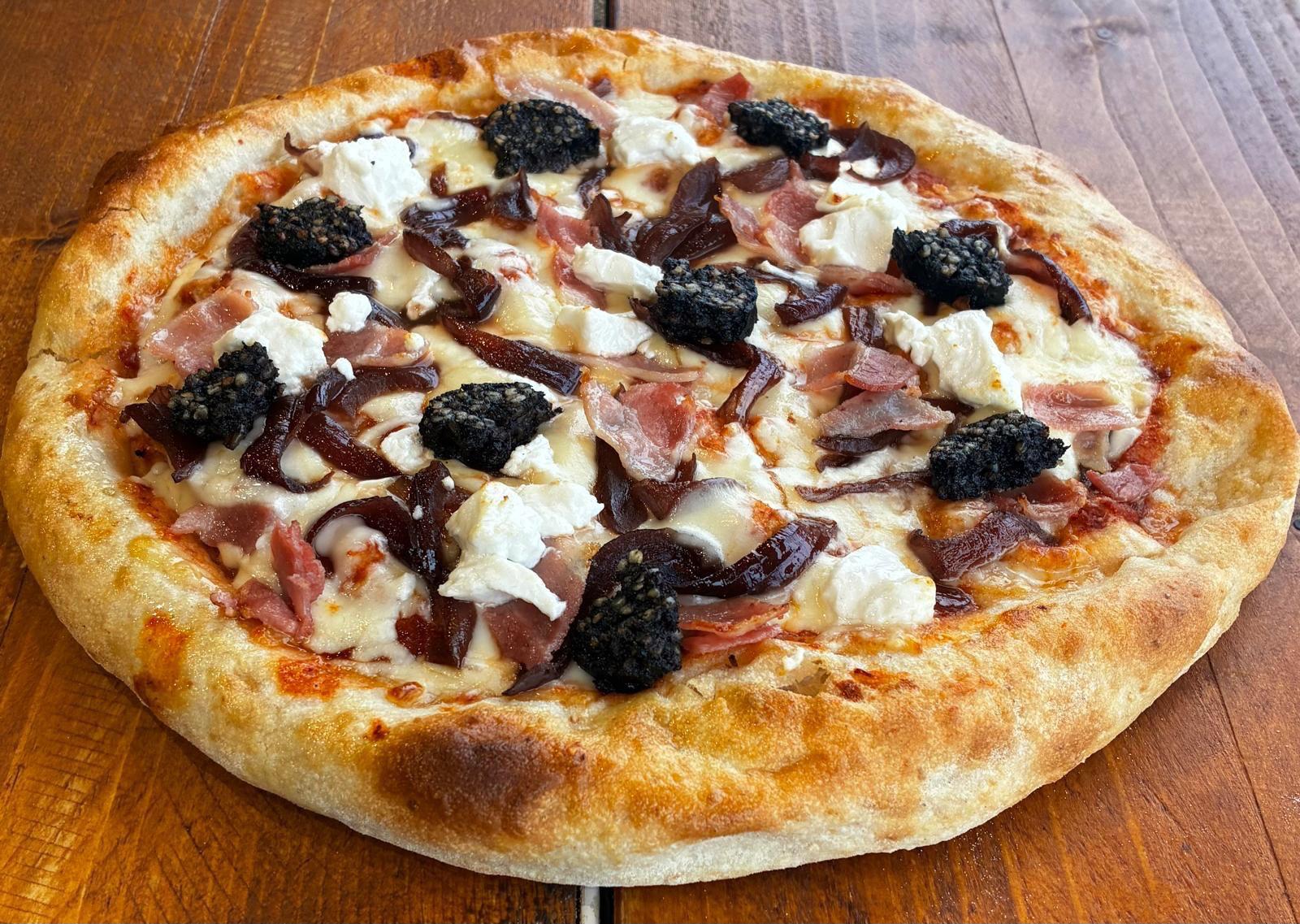 NERO: House tomato sauce, fior di latte mozzarella, goat’s cheese, crumbled crispy black pudding, streaky bacon, caramelised onions