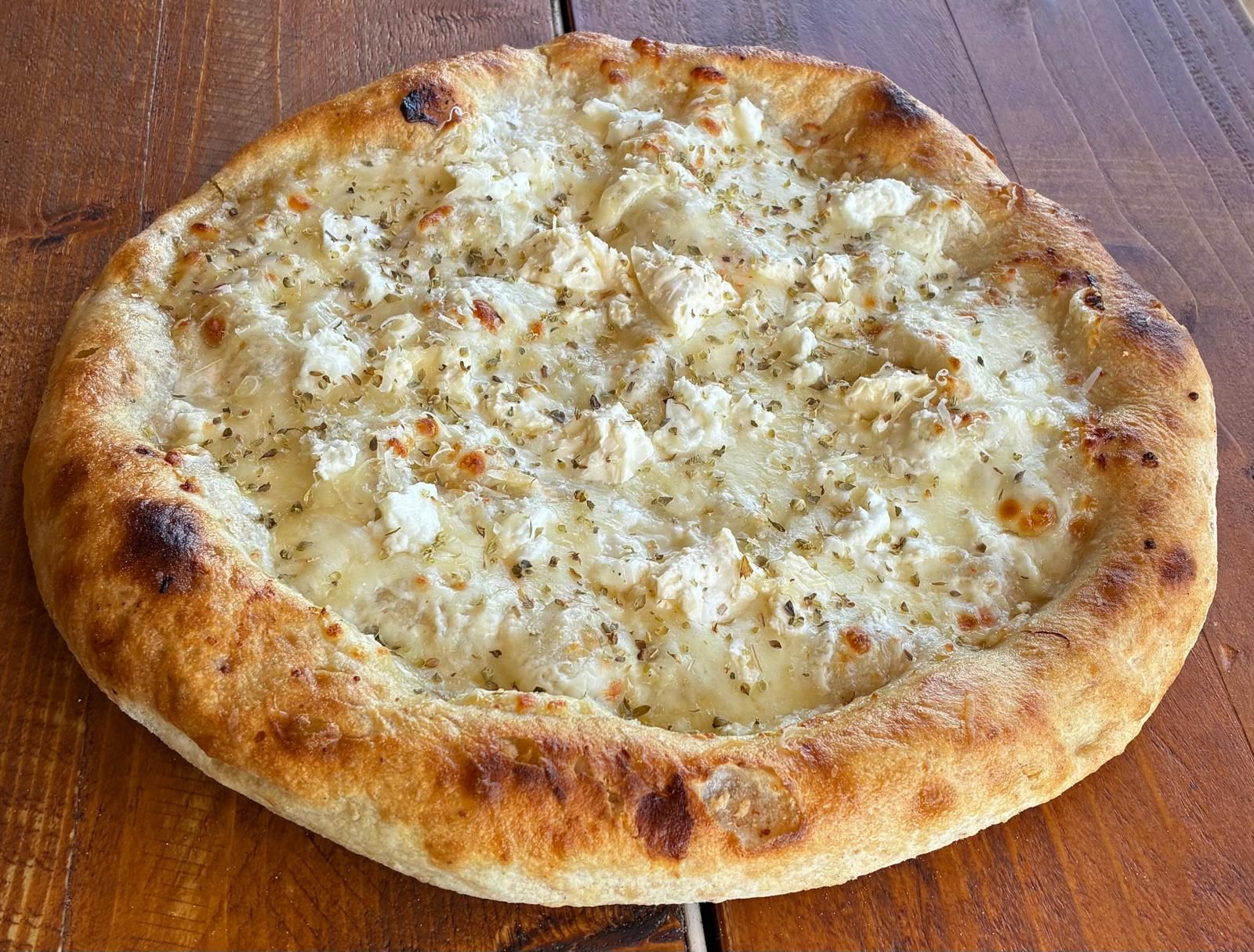 QUATTRO:  Signature white sauce, fior dilate mozzarella, goat’s cheese, feta, parmigiano reggiano